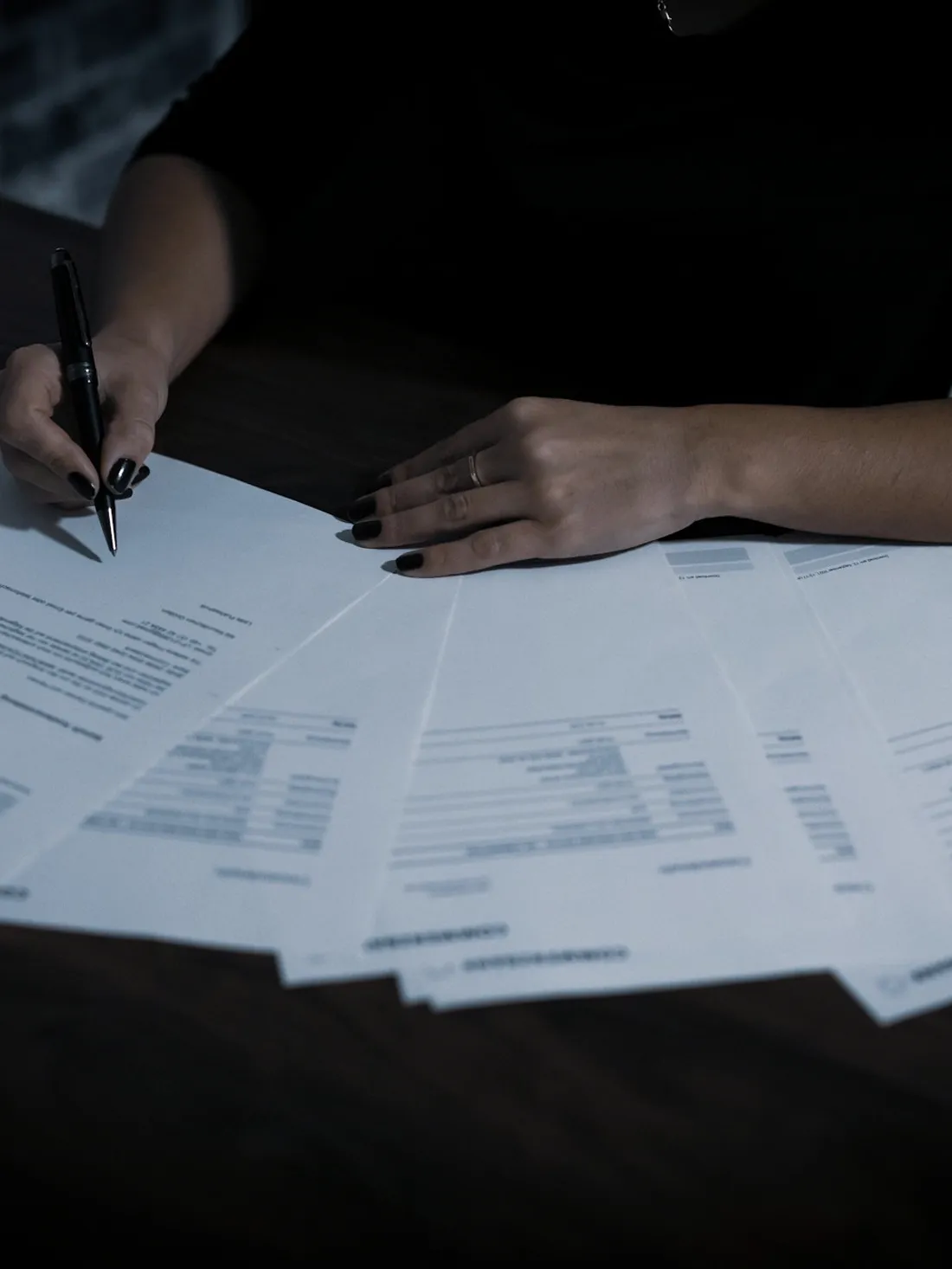 Paperwork spread out and being checked over line by line